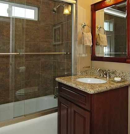 Two luxury bathrooms with granite, new fixtures, and high-end details