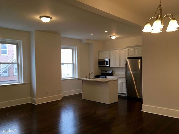 Apt. 3 open floor plan of living room, kitchen, and dining r