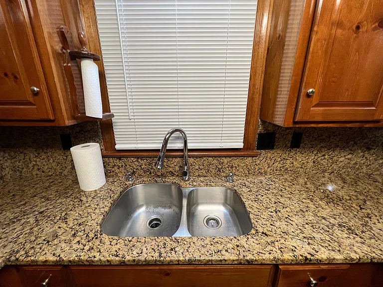 Photo of kitchen sink with recently replaced fixtures.