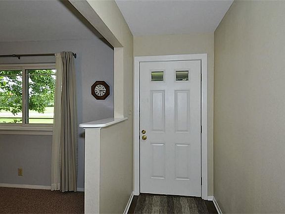 This is a view of the foyer, to the left is a room that could act as a study, formal living or formal dining.
