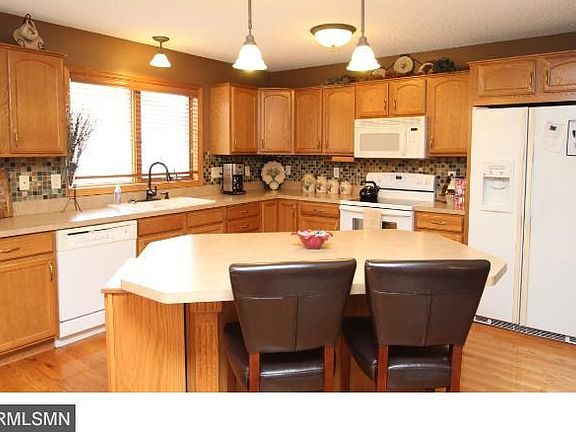 Open sunny kitchen with a great center island, tile backsplash and hardwood floors!
