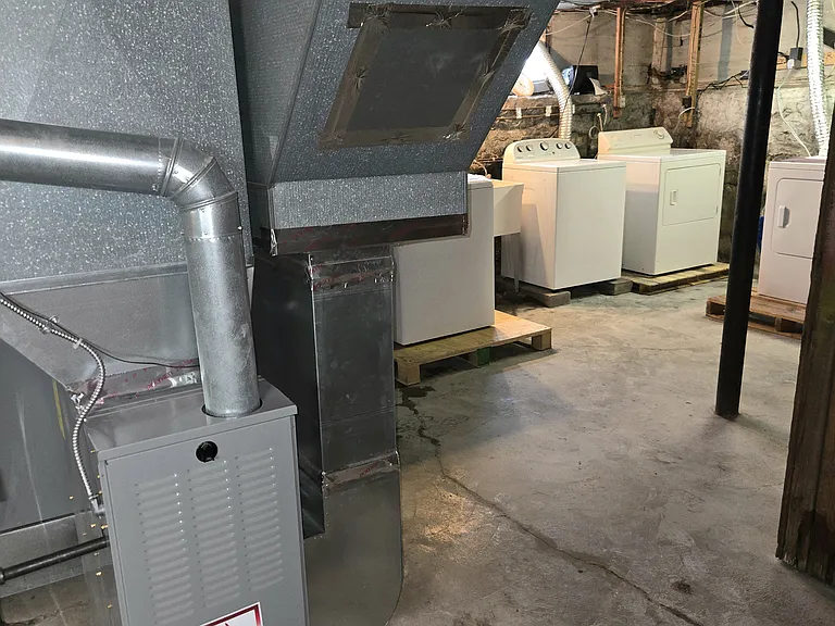 Newer furnace to the right and dryer to the far right for lower rental unit