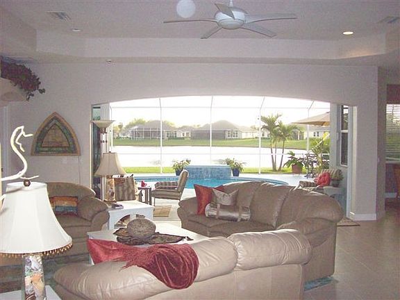 Living room looking out to pool and lake beyond