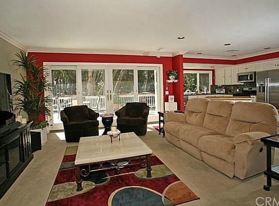 Open floor plan concept with large living room overlooking the deck and trees