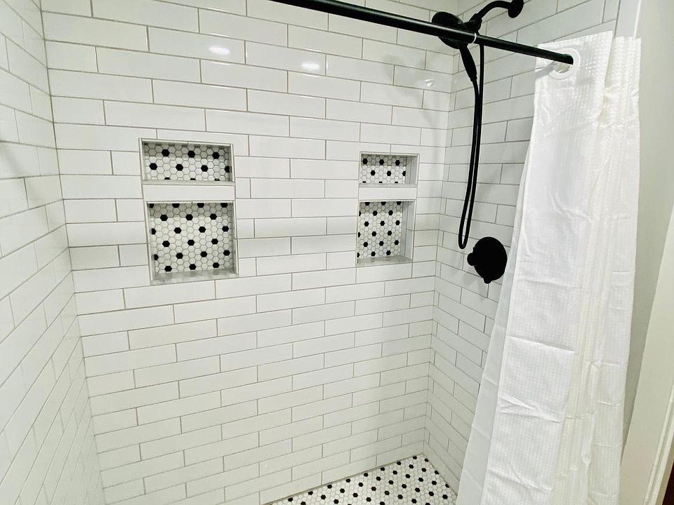 Beautiful tiled bathroom, done in accordance with the style and age of the home.