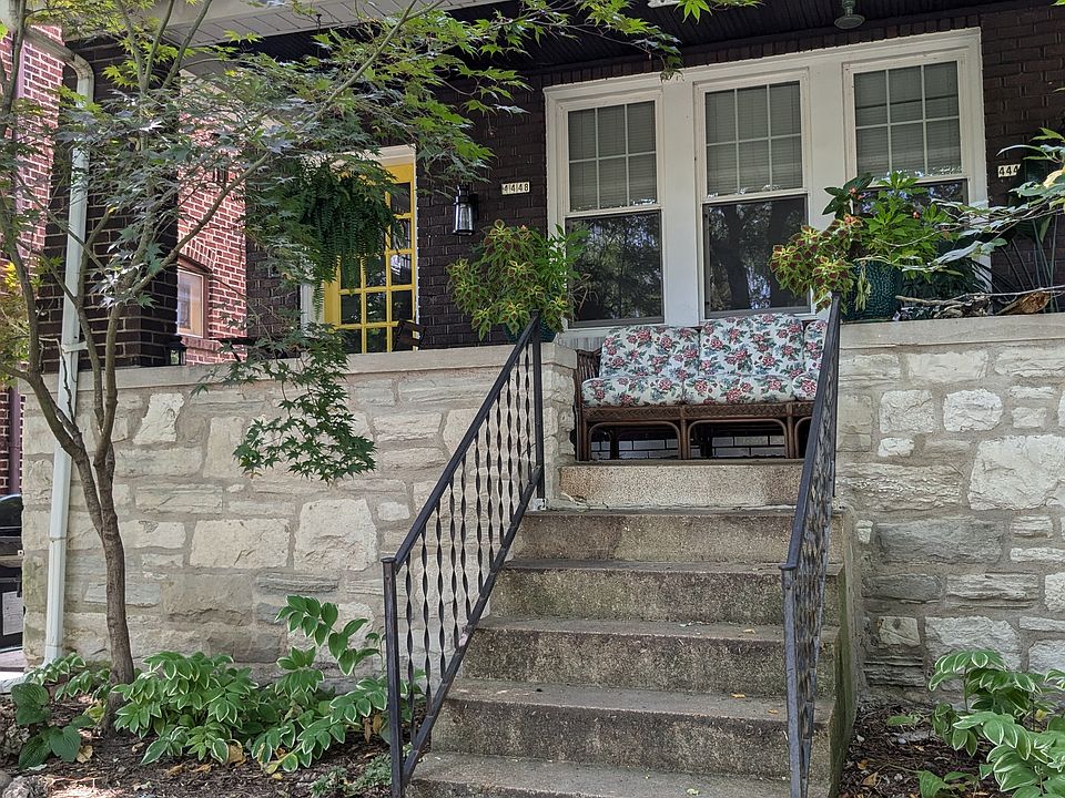 Steps up to shared front porch, entry on L side