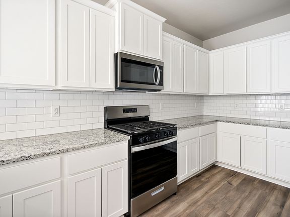 The kitchen of the Sudan has beautiful white wood cabinets.