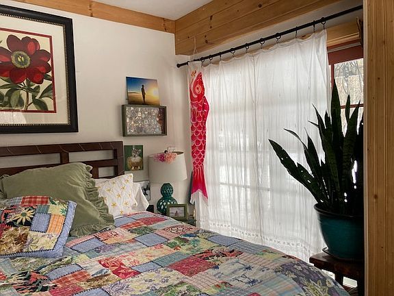 Bedroom with large french doors open to the forest view