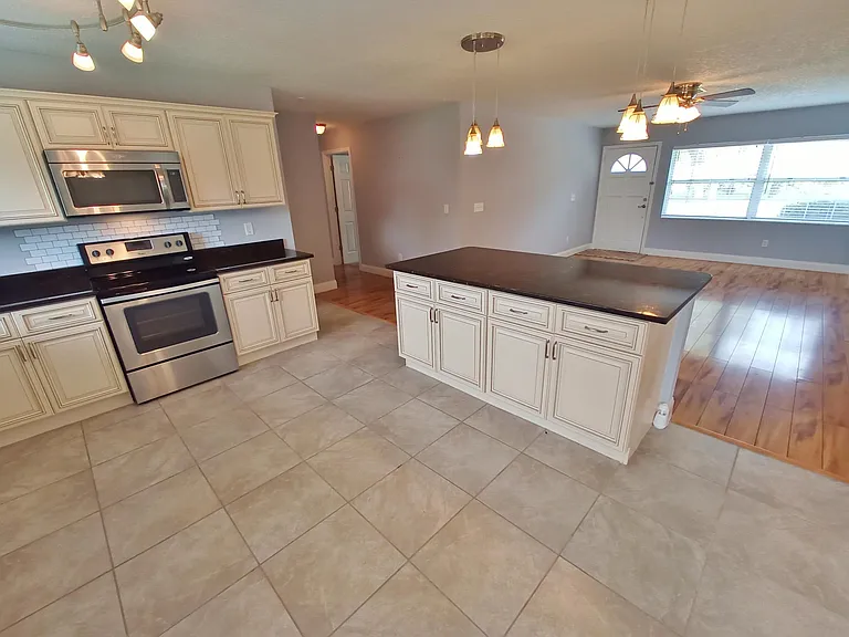 Kitchen showing living and hallway