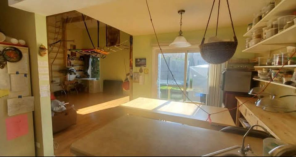 View of the dining room, living room, and the backyard from the kitchen.