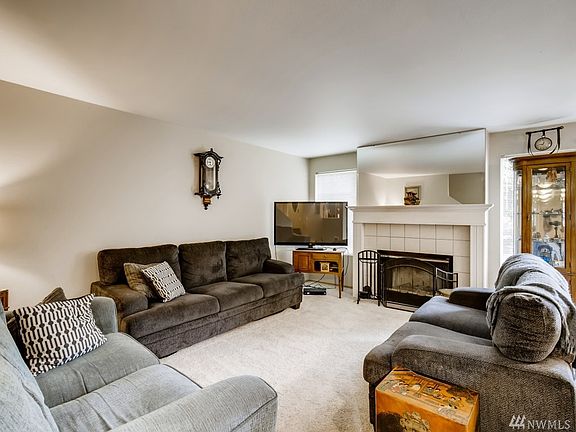 Large living room with a wood burning fireplace.