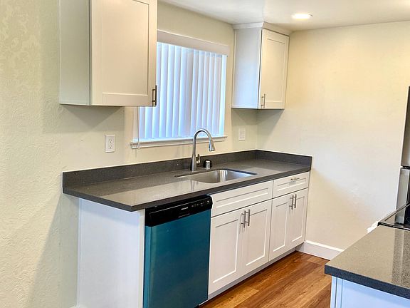 Kitchen was newly renovated with new flooring, cabinetry, counter tops, faucet fixtures, sink, garbage disposal, induction stove and oven, dishwasher, and refrigerator.