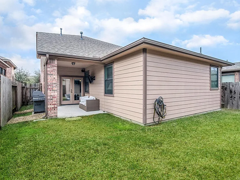 Covered patio overlooking a fully fenced backyard_perfect for relaxing or entertaining.