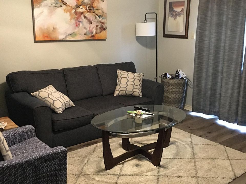 Light gray walls and gray vinyl plank throughout apartment.