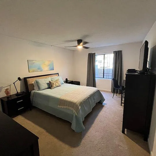 Fully furnished bedroom with small desk area