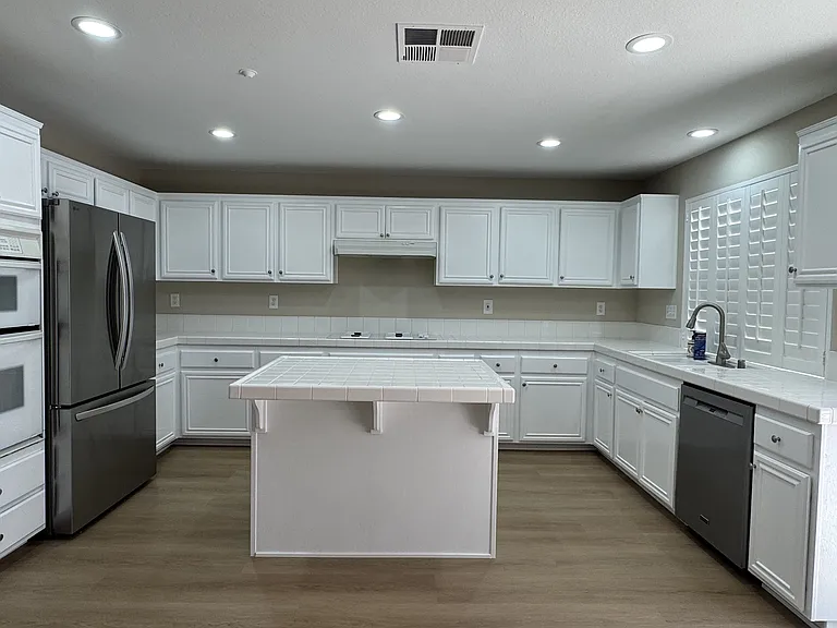 Kitchen with new LG refrigerator and whirlpool dishwasher