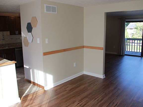 Dining room looking into kitchen and living room