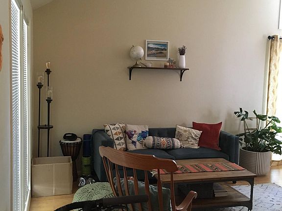 View of living room with floor to ceiling windows and vaulted ceiling