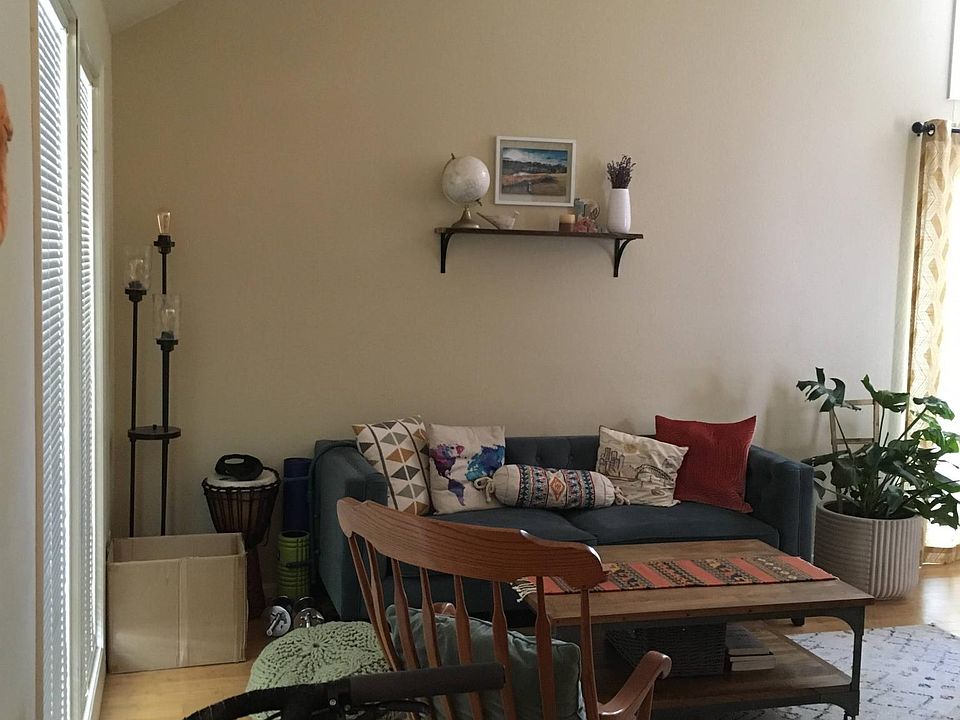 View of living room with floor to ceiling windows and vaulted ceiling