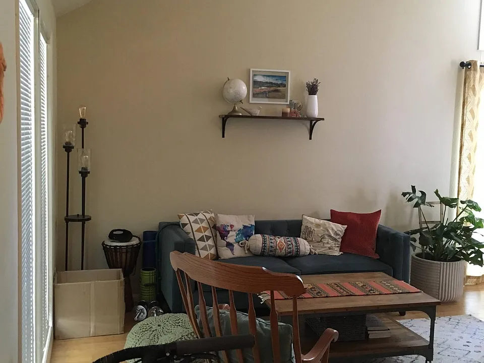 View of living room with floor to ceiling windows and vaulted ceiling