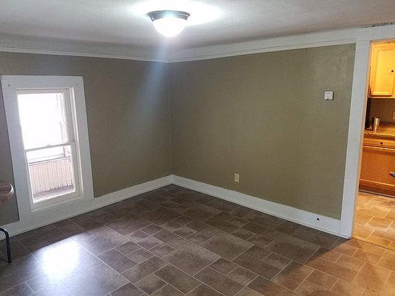 Dining room, window looking through porch. Kitchen to right.