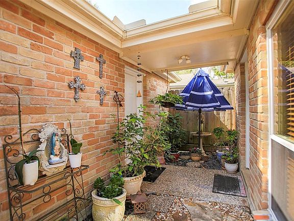 This shot shows off the side entrance of the home from the garage. You can turn this small area into another outside sitting area with a garden of plants and flowers.