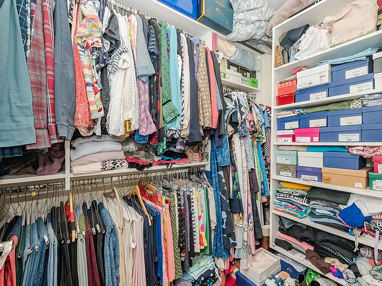 Very large walk in closet with high ceilings