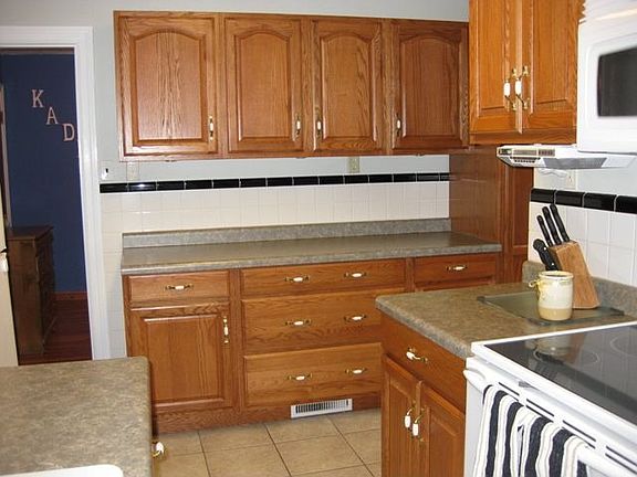 Remodeled kitchen with lovely wood cabinets and ceramic tile floor