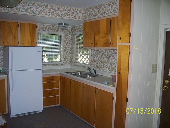 Kitchen, white stove to the left of the refrigerator.