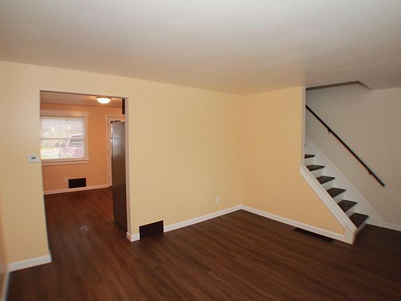 Living with transition into dining area and kitchen.