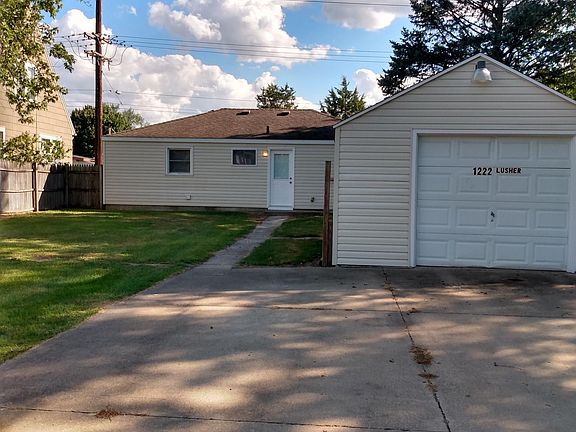 House and parking area and garage from alleyway
