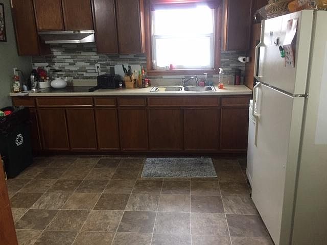 Kitchen with new vinyl flooring and counter. All appliances included.