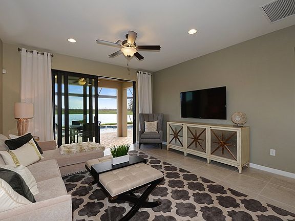 Model Representation Gathering room with glass sliders open to the screened-in, extended patio