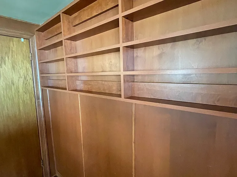 Wall of cherry custom shelving.