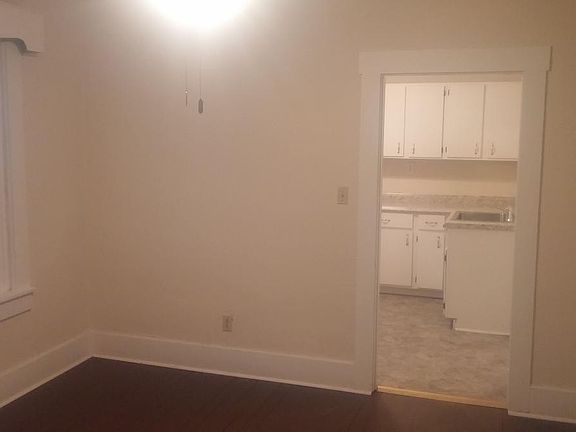Spacious dining room looking into kitchen.