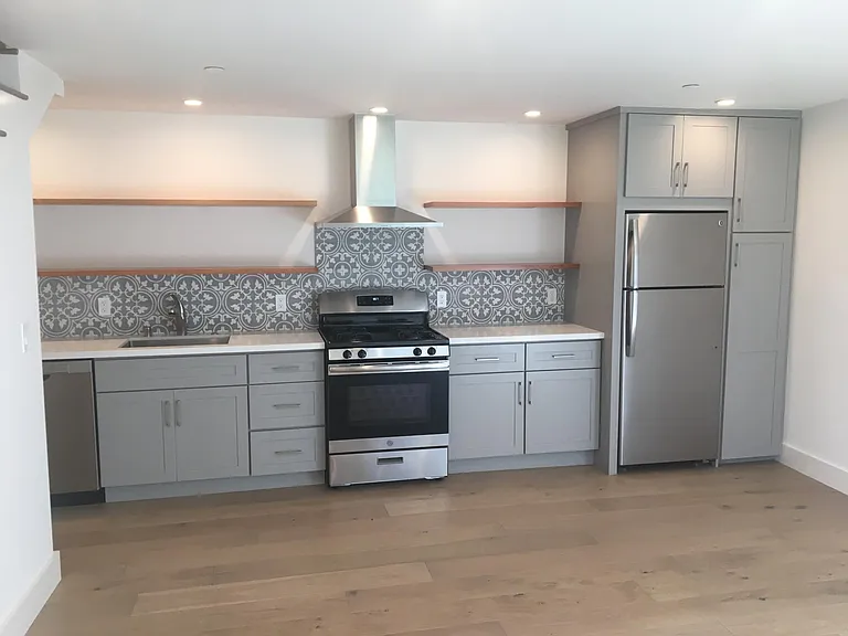 Kitchen with stainless Steel appliances and gas range.