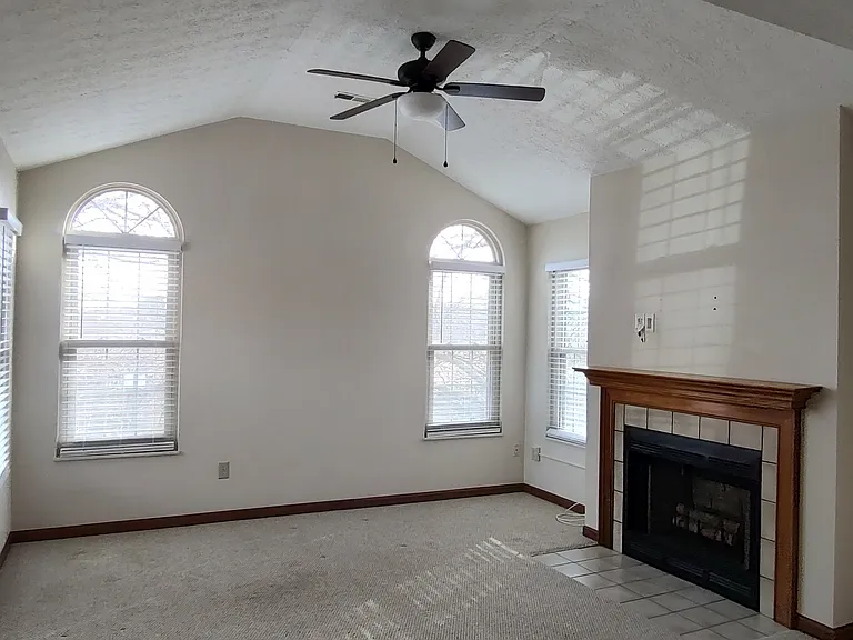 Living room view. Cathedral Ceiling. Fireplace is woodburning but not available for use other than an electric insert.
