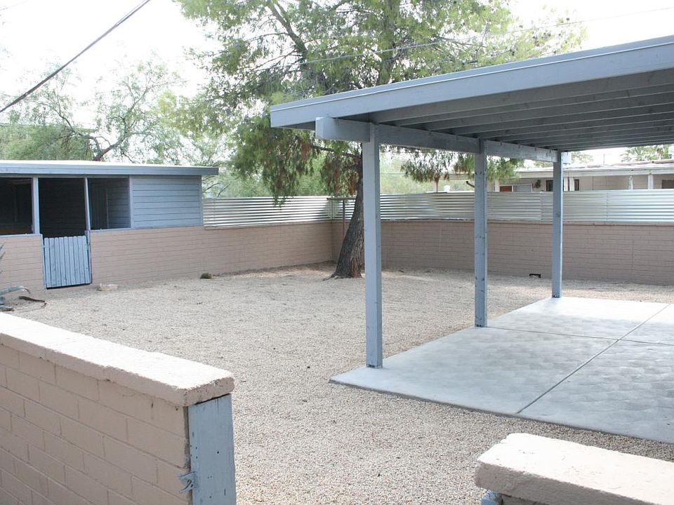coverd patio and back yard. View of carport.