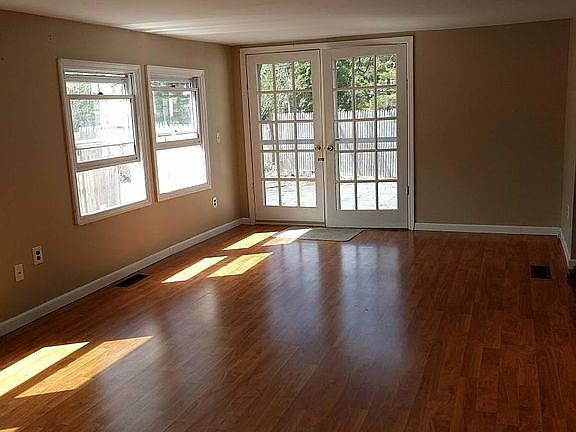 living room with French door to patio and yard