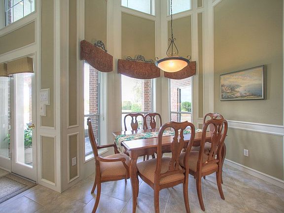 Spacious eat in kitchen with windows overlooking the pool area