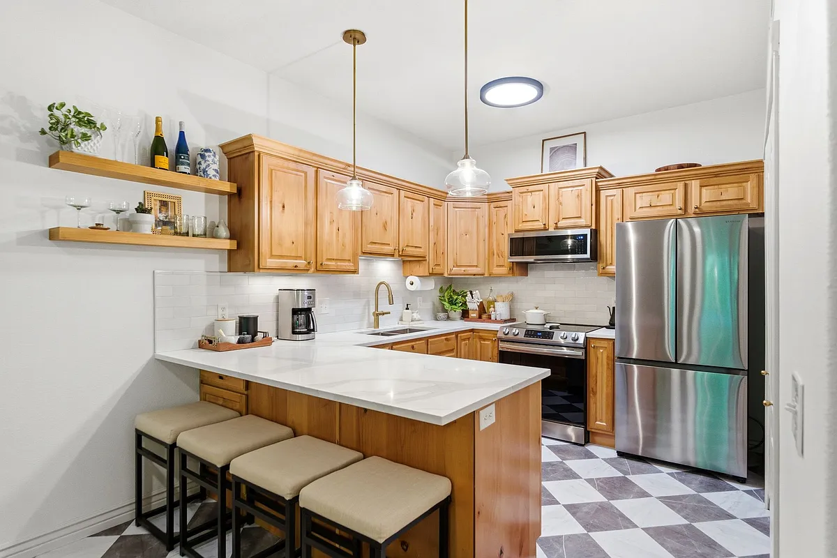 Kitchen with quartz countertops, tile backsplash, new stainless steel appliances - 1174 E 3300 S