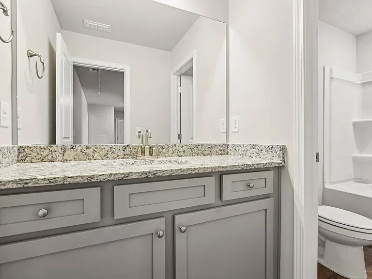 Secondary bathroom with double vanity and shower/tub combo