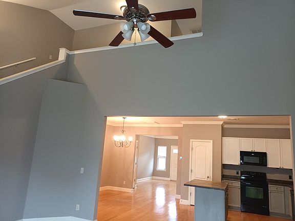 Upstairs balcony overlooking great room. Dining room and kitchen open to great room.