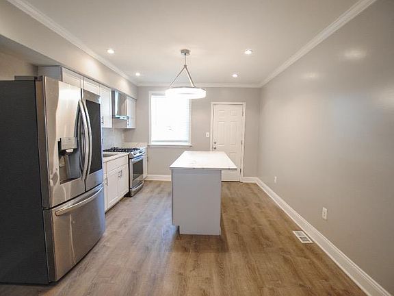 Walk in to an open first level; head to the back of the house to find the upgraded kitchen