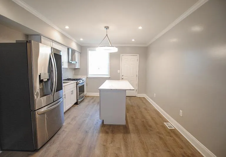 Walk in to an open first level; head to the back of the house to find the upgraded kitchen