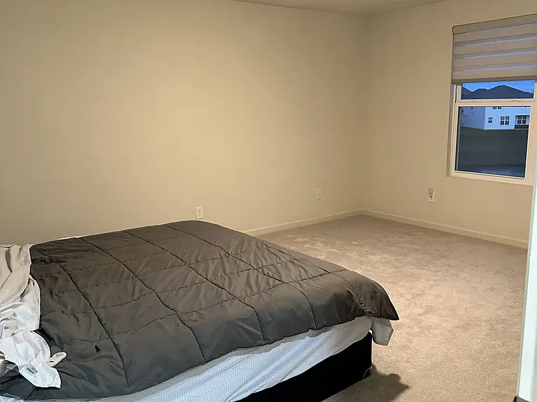 Master bedroom featuring a stunning lake view and a warm, welcoming sunrise each morning