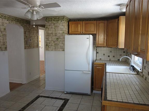Eat-in kitchen with plenty of cabinet space and overlooks the back yard. Kitchen includes a refrigerator, gas stove, dishwasher and microwave.