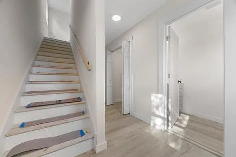 Stairway to second floor. Finished wood treads- protected during final construction