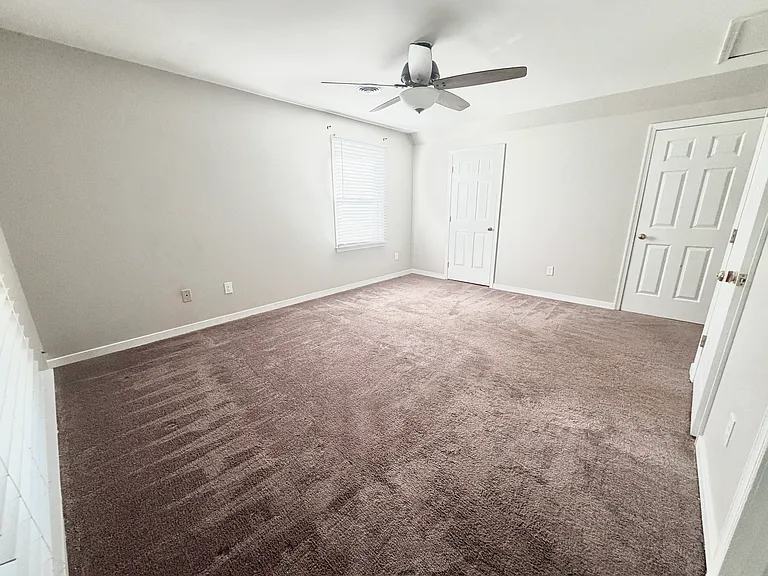 Bedroom 3 upstairs, with ceiling fan, and extremely spacious his-and-hers full size closets