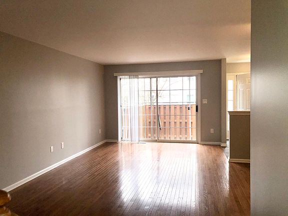 Wood floors and double doors leading to the patio